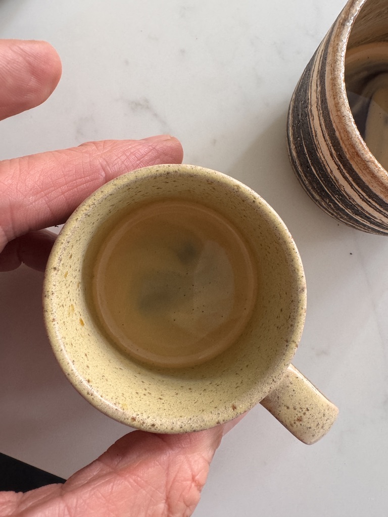 Market Yard espresso with hazel-gold crema in a handmade yellow cup