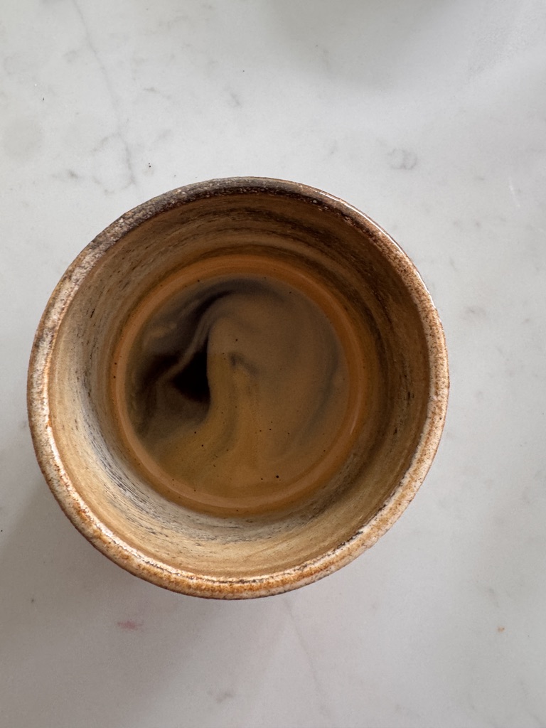 Freshly extracted Lomond Market Yard espresso in a ceramic cup
